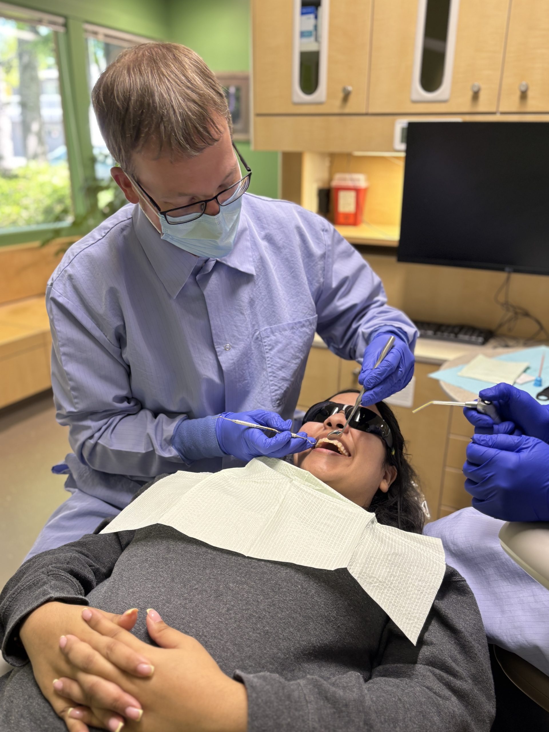 Dr Ben_working_with_patient Male White Bird Dental Clinic dentist working on a patient.